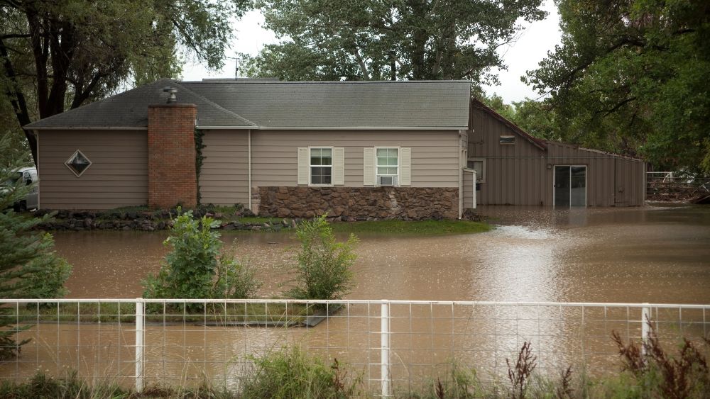 floodwaters-surrounding-brown-house